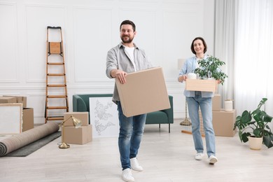 Photo of Moving day. Happy couple with their belongings in new home