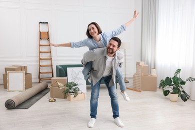 Photo of Moving day. Happy couple having fun in their new home