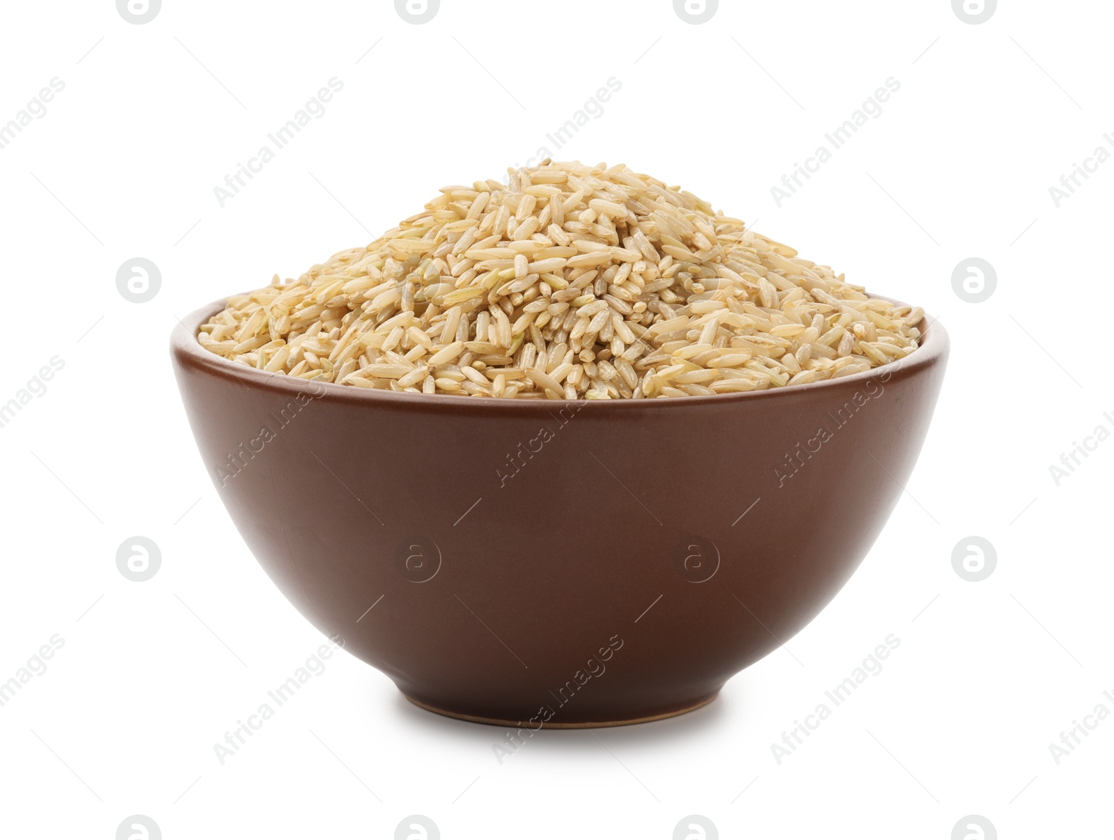 Photo of Raw brown rice in bowl isolated on white