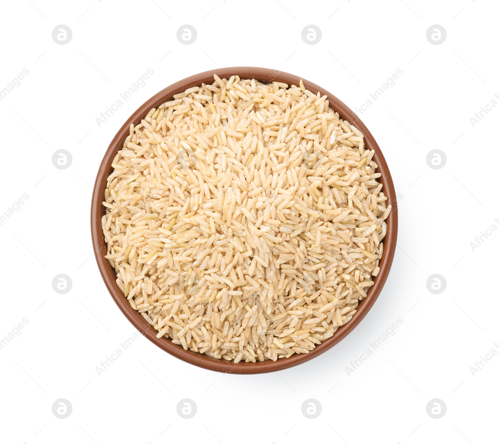 Photo of Raw brown rice in bowl isolated on white, top view