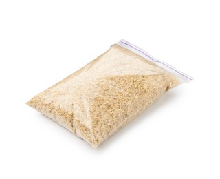 Photo of Raw brown rice in plastic bag isolated on white