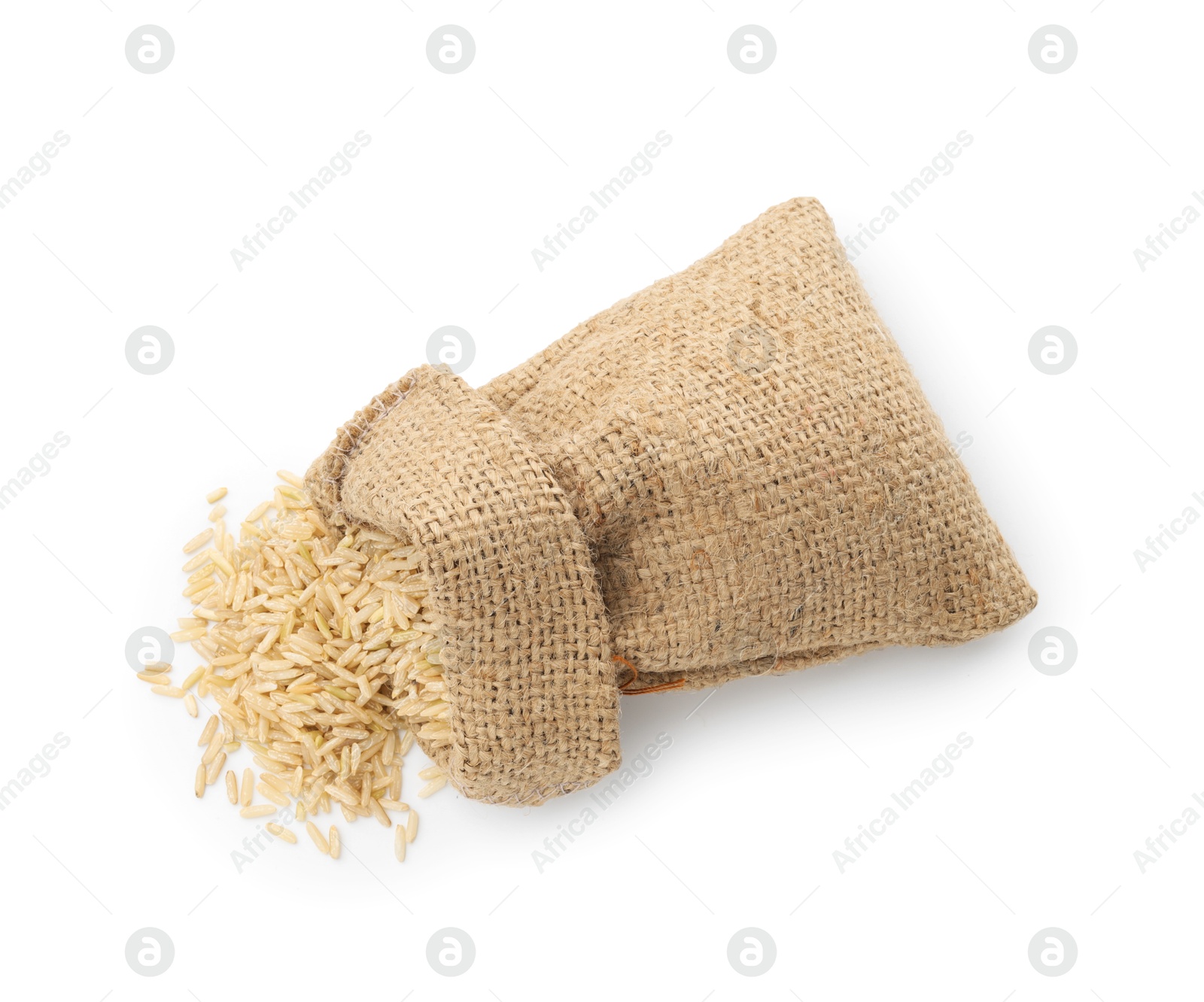 Photo of Raw brown rice in sack isolated on white, top view