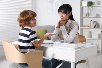 Little boy having consultation with psychologist in office