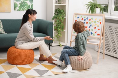 Photo of Psychologist having consultation with little boy in office