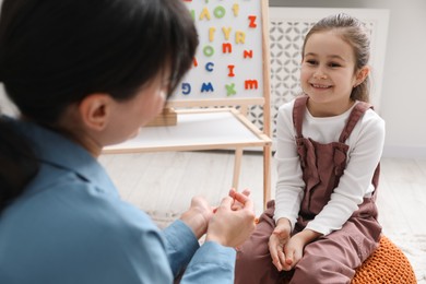 Little girl having consultation with psychologist in office