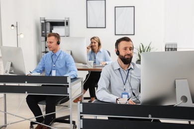 Photo of Technical support call center. Team of operators working in office