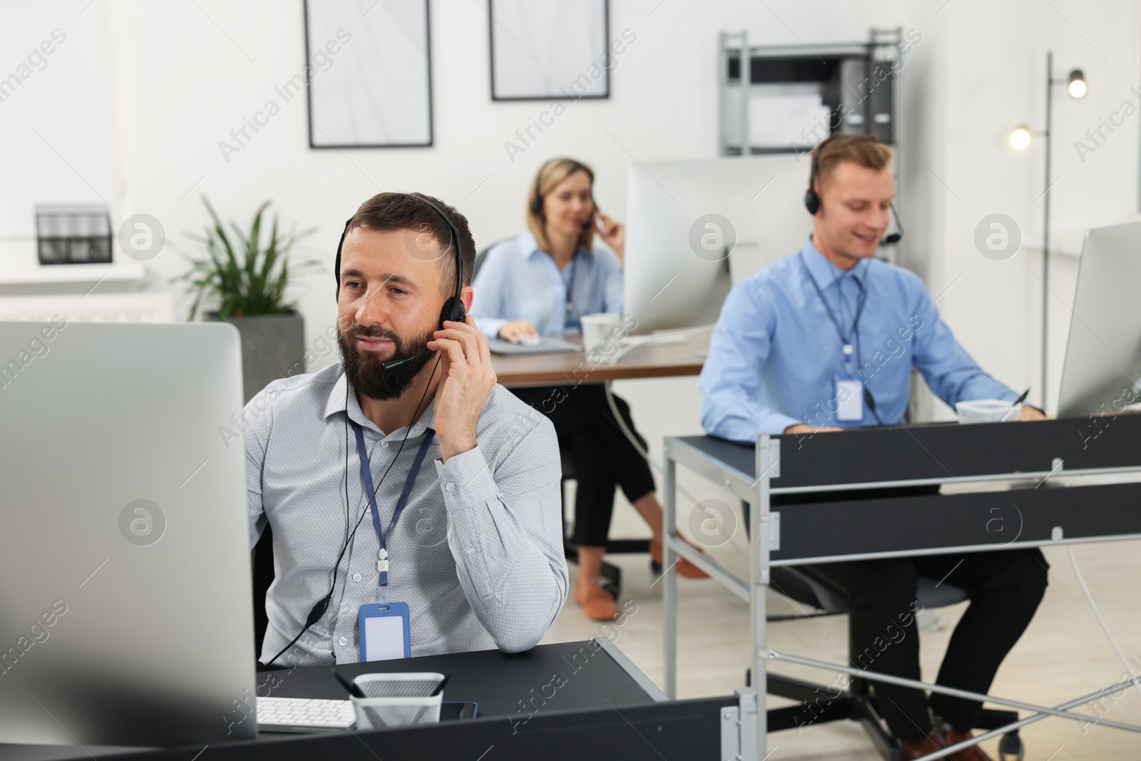 Photo of Technical support call center. Team of operators working in office