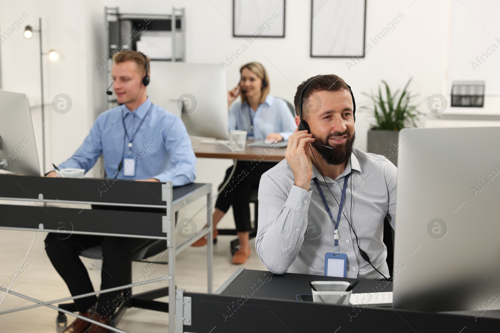 Photo of Technical support call center. Team of operators working in office