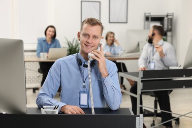 Photo of Technical support call center. Team of operators working in office