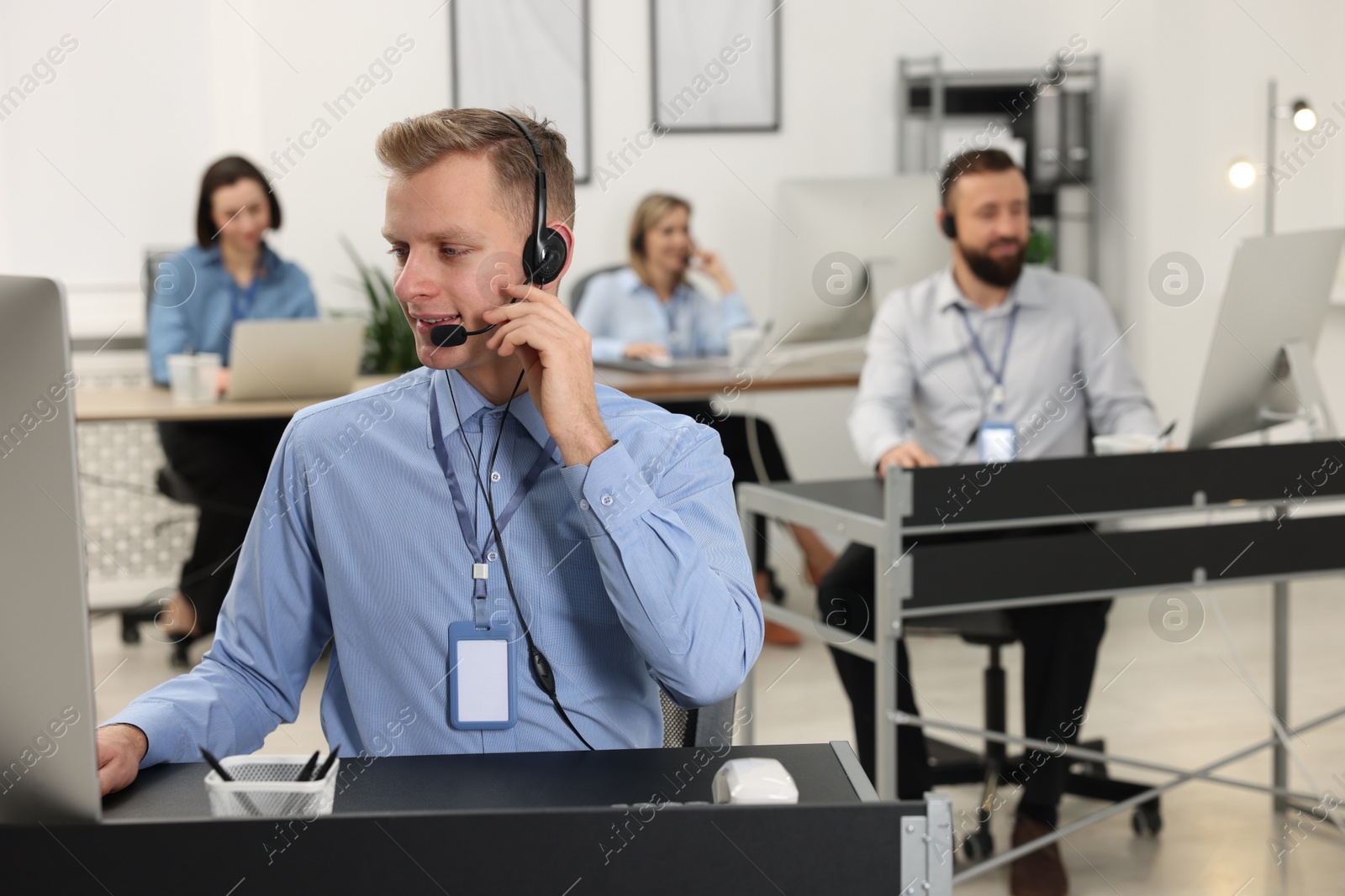 Photo of Technical support call center. Team of operators working in office