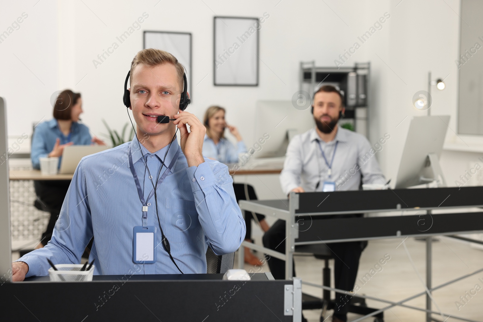 Photo of Technical support call center. Team of operators working in office