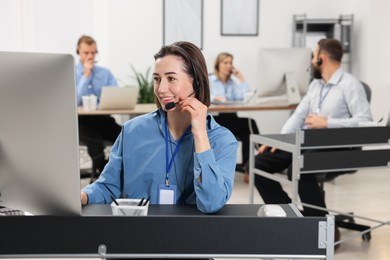 Photo of Technical support call center. Team of operators working in office