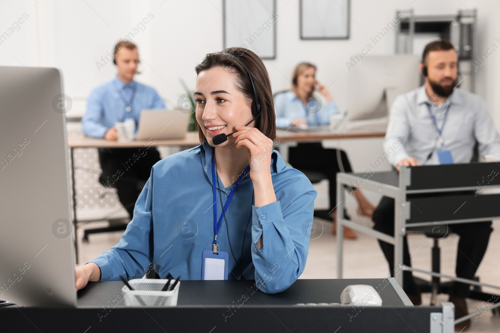 Photo of Technical support call center. Team of operators working in office