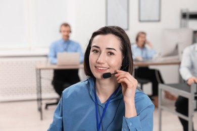 Photo of Technical support call center. Smiling operator working in office