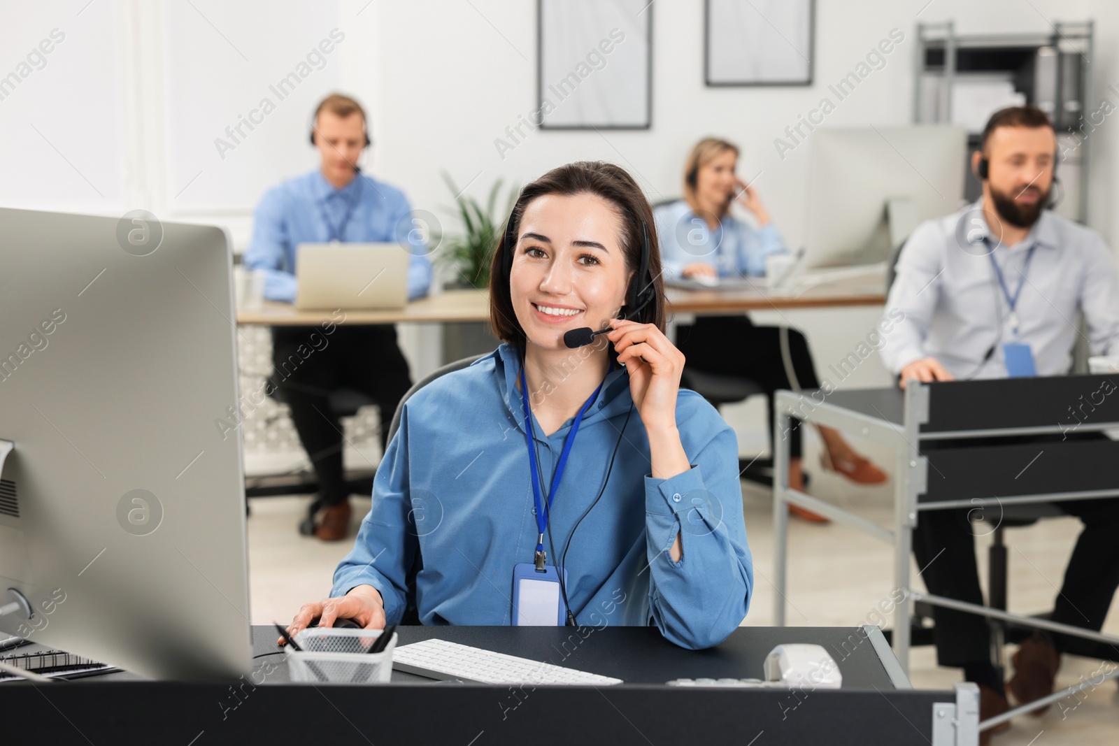 Photo of Technical support call center. Smiling operator working in office