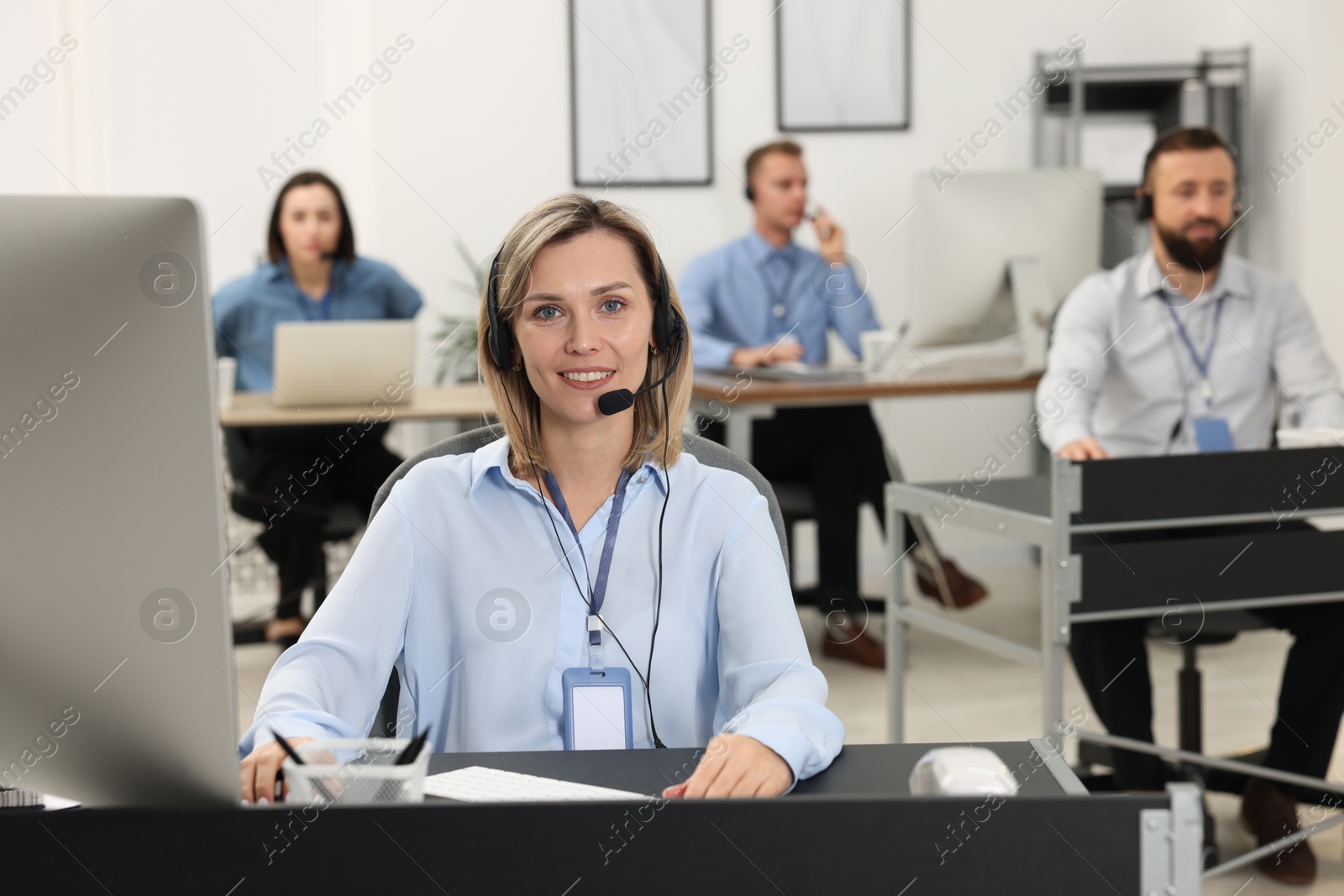 Photo of Technical support call center. Team of operators working in office