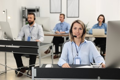 Photo of Technical support call center. Team of operators working in office