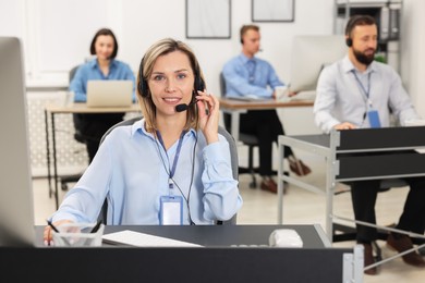 Photo of Technical support call center. Team of operators working in office