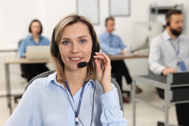 Photo of Technical support call center. Smiling operator working in office