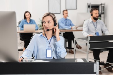 Photo of Technical support call center. Team of operators working in office