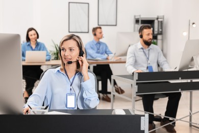 Photo of Technical support call center. Team of operators working in office