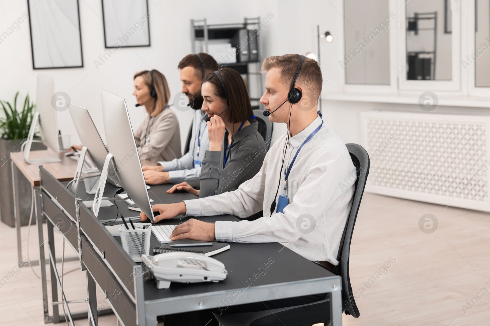 Photo of Technical support call center. Team of operators working in office