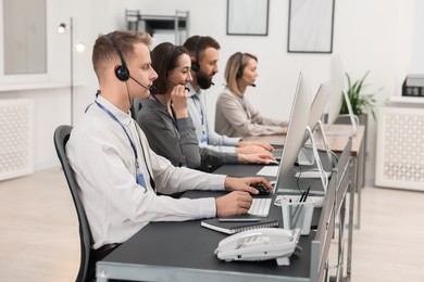 Photo of Technical support call center. Team of operators working in office