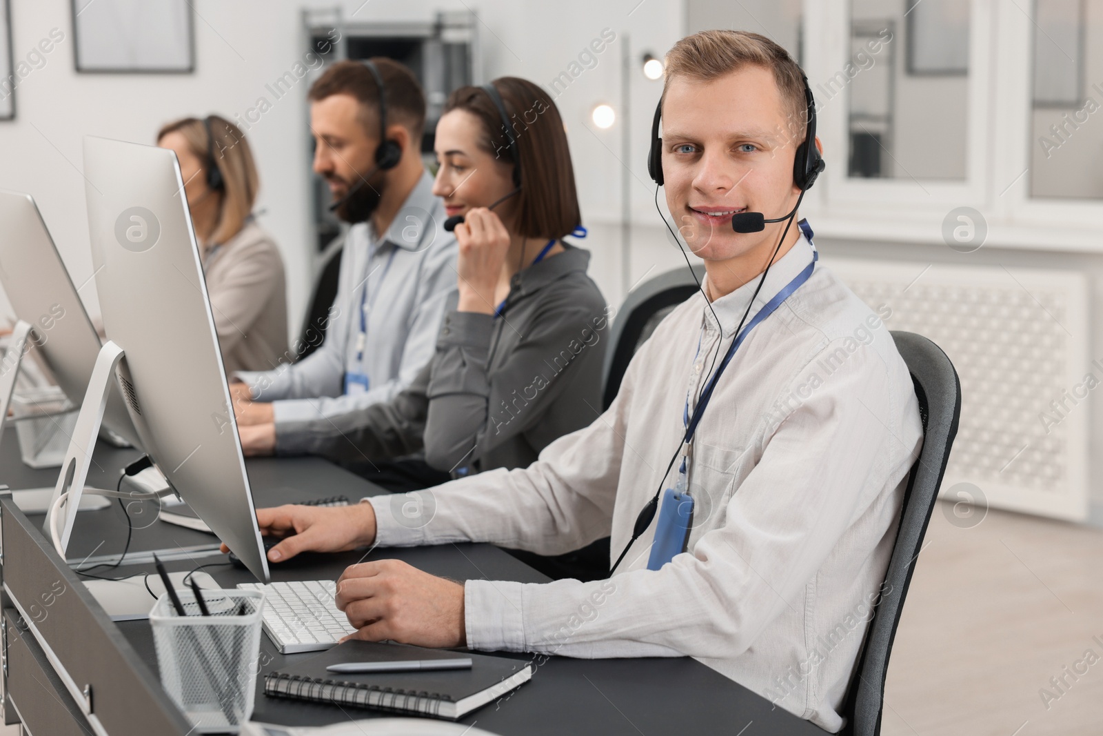 Photo of Technical support call center. Team of operators working in office