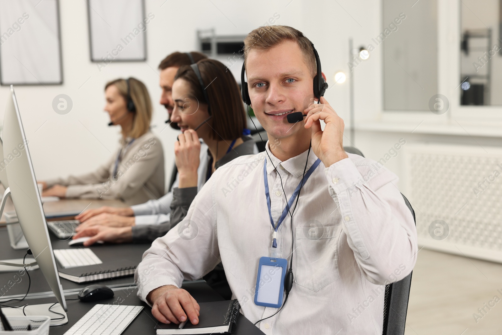 Photo of Technical support call center. Team of operators working in office