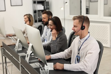 Photo of Technical support call center. Team of operators working in office