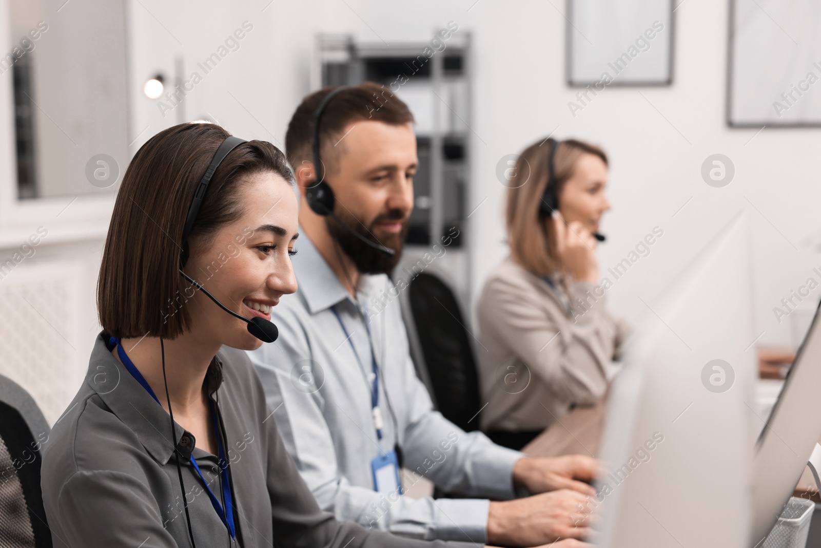 Photo of Technical support call center. Team of operators working in office