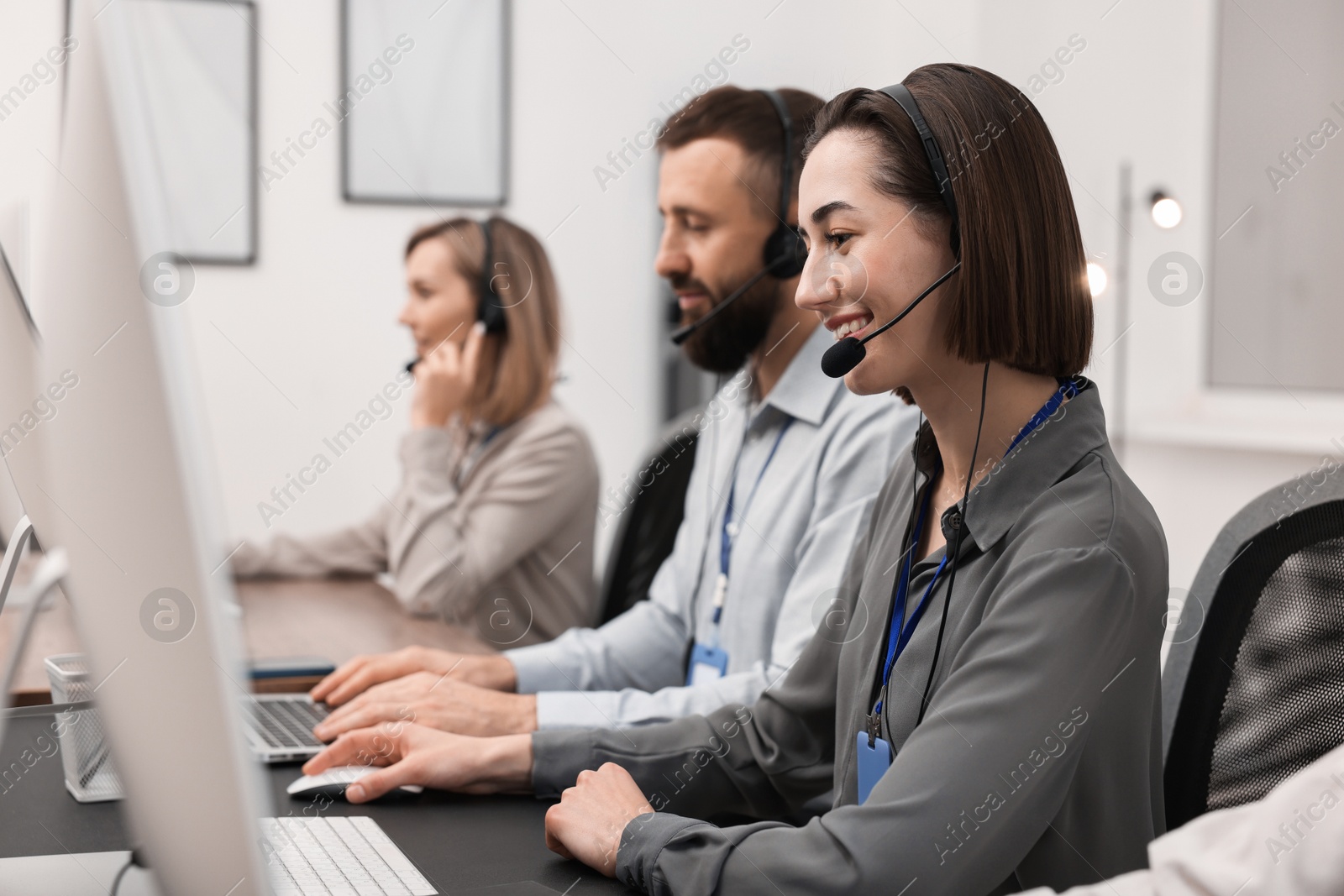 Photo of Technical support call center. Team of operators working in office