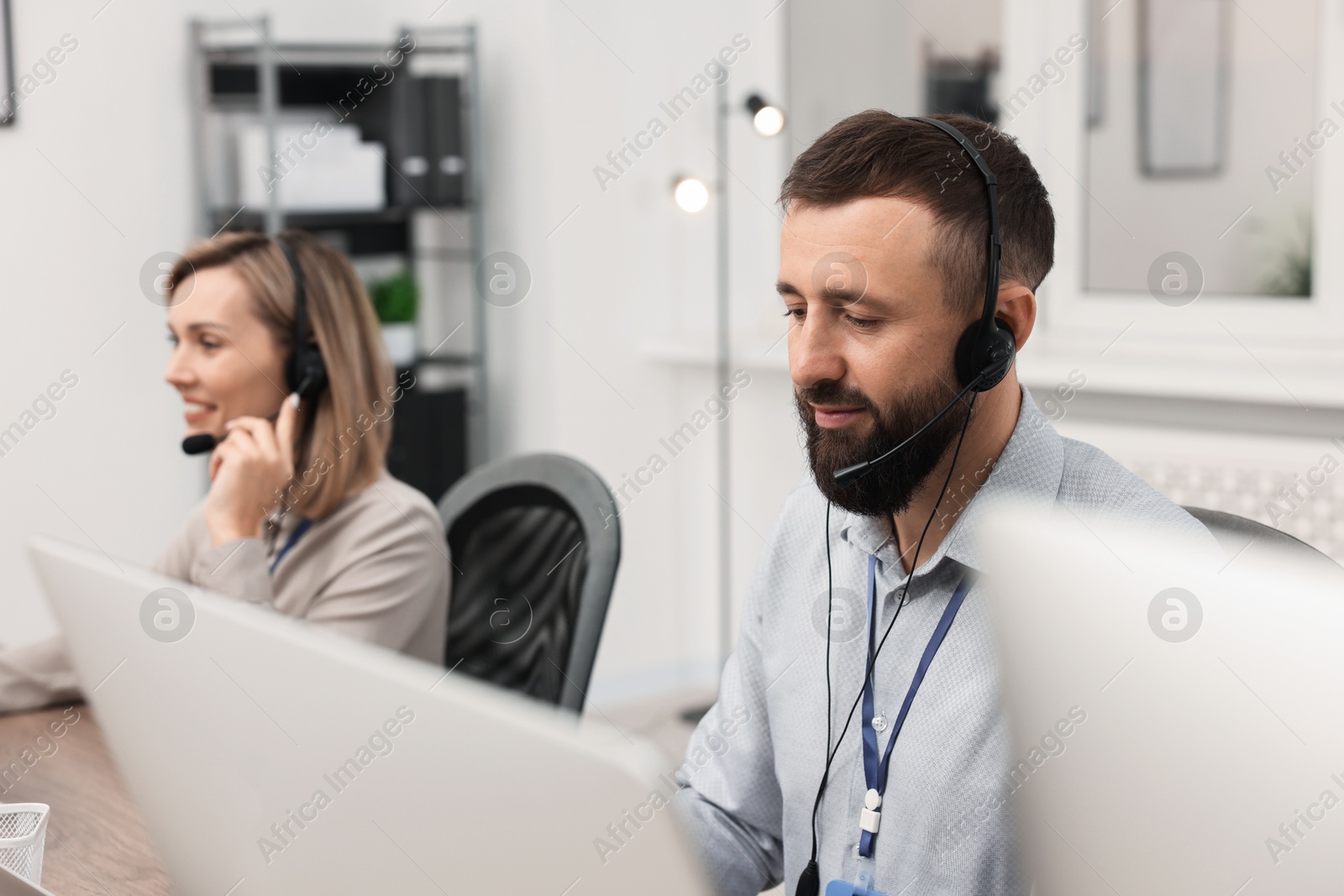 Photo of Technical support call center. Operators working in office