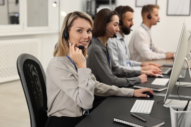 Photo of Technical support call center. Team of operators working in office