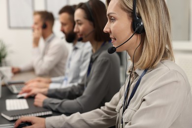 Photo of Technical support call center. Team of operators working in office