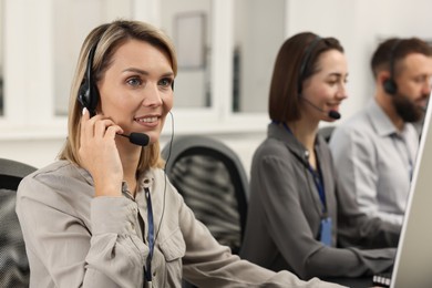 Photo of Technical support call center. Team of operators working in office