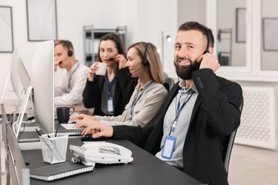 Photo of Technical support call center. Team of operators working in office