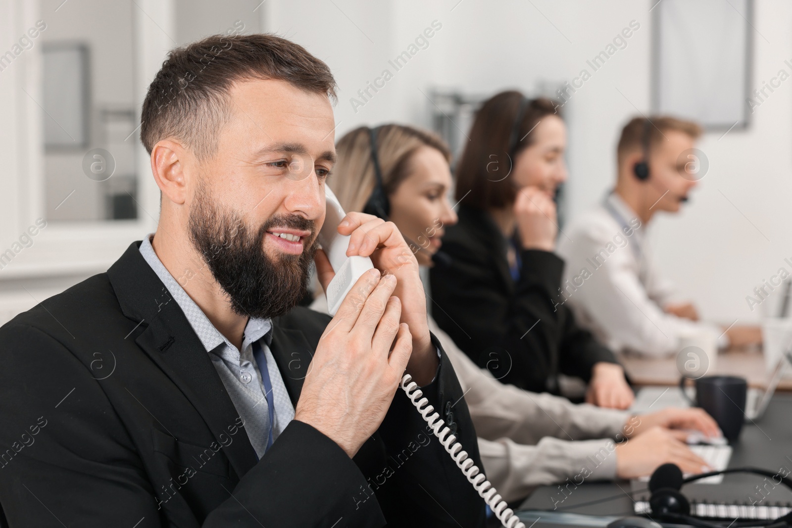 Photo of Technical support call center. Team of operators working in office