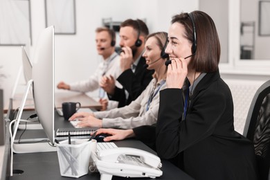 Photo of Technical support call center. Team of operators working in office