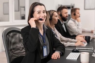 Photo of Technical support call center. Team of operators working in office