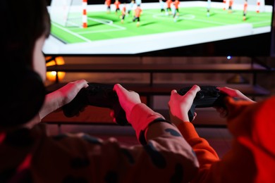 Photo of Little kids playing video game at home, closeup