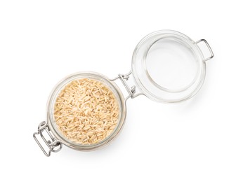 Photo of Raw brown rice in open jar isolated on white, top view