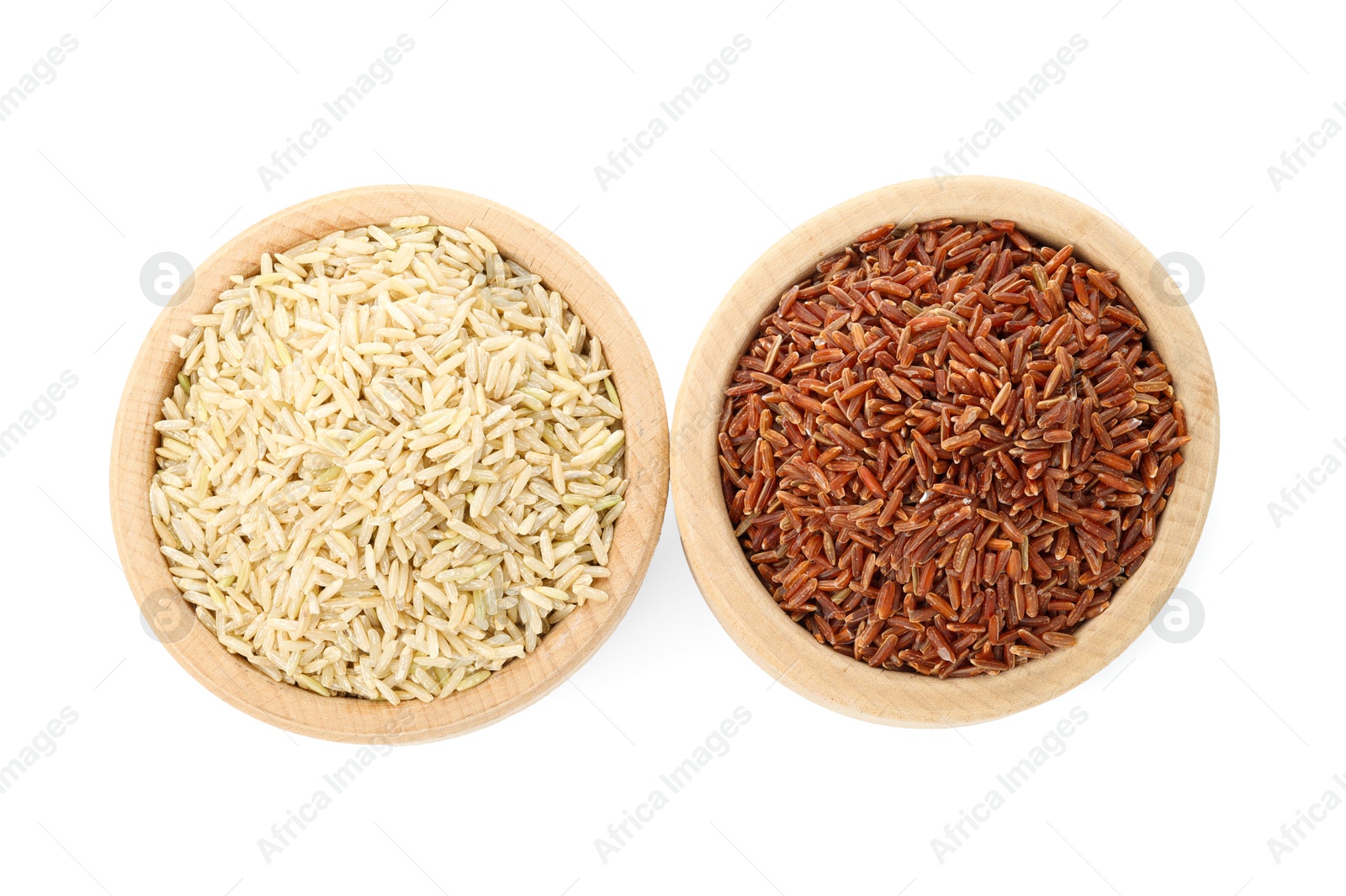 Photo of Different sorts of raw brown rice isolated on white, top view