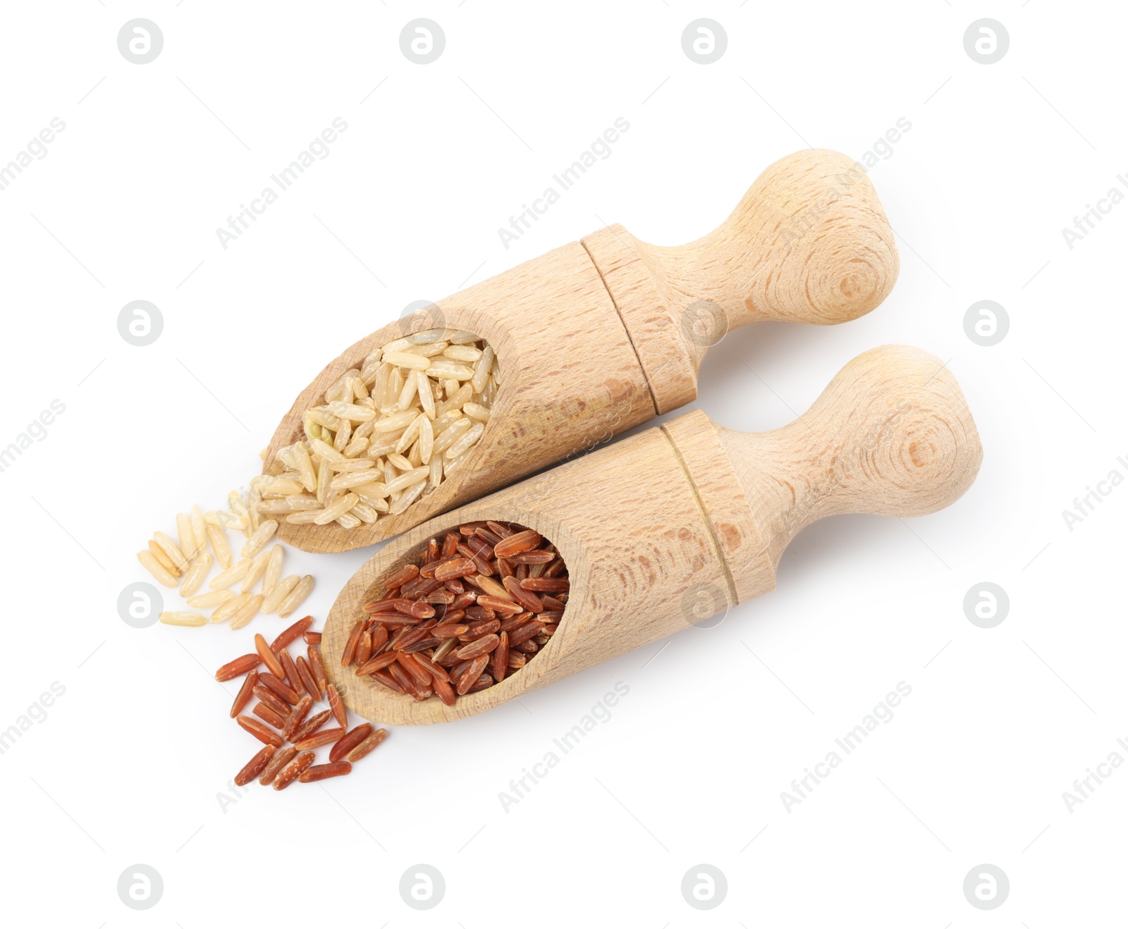 Photo of Different sorts of raw brown rice isolated on white, top view