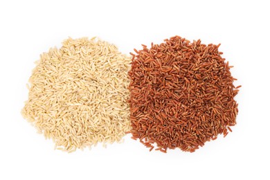 Photo of Different sorts of raw brown rice isolated on white, top view