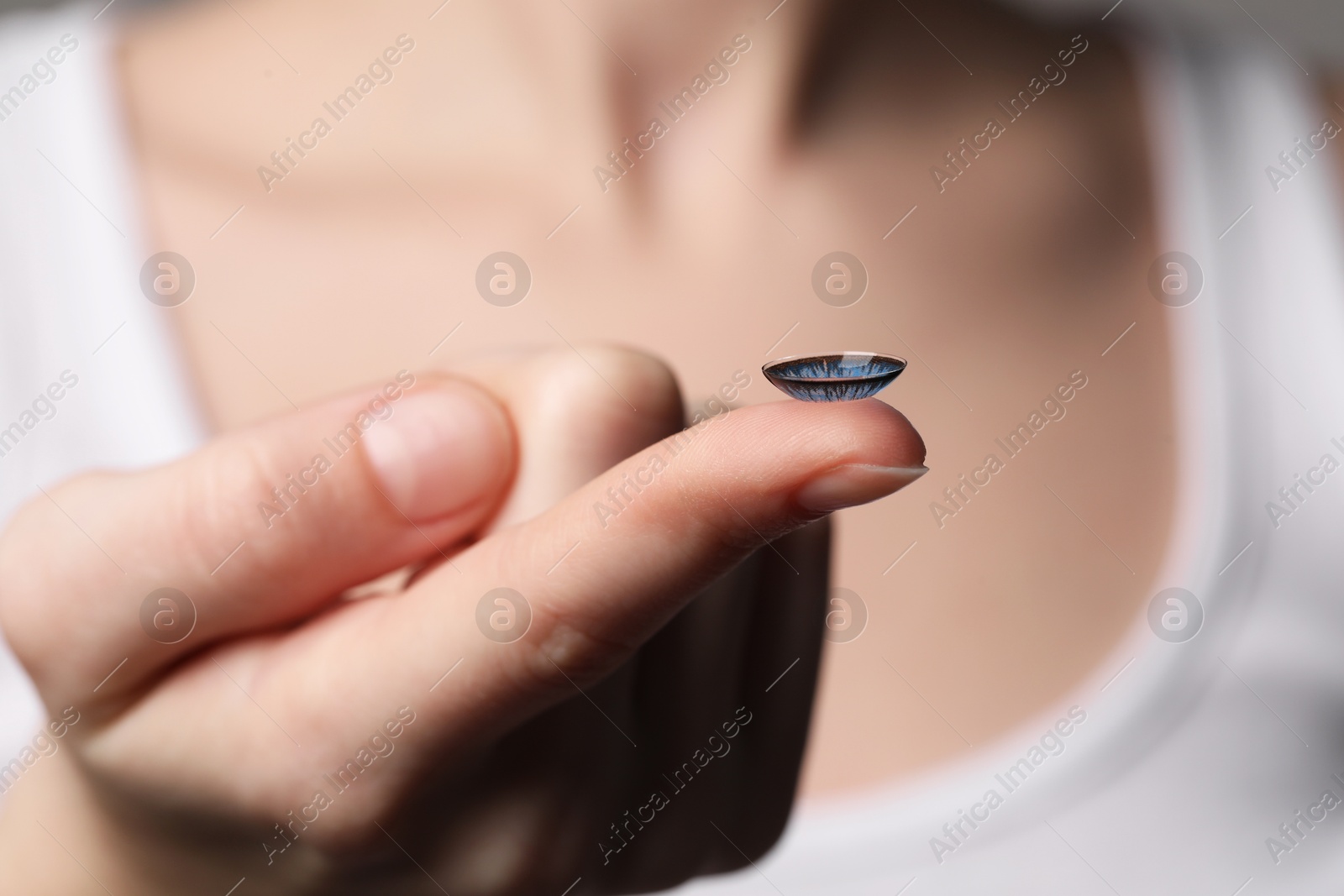 Photo of Woman with blue color contact lens, closeup. Selective focus