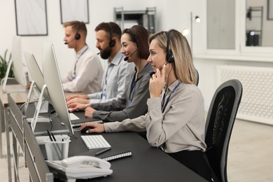 Photo of Technical support call center. Team of operators working in office