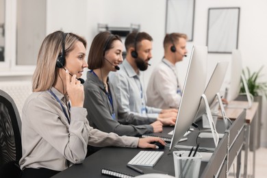 Photo of Technical support call center. Team of operators working in office