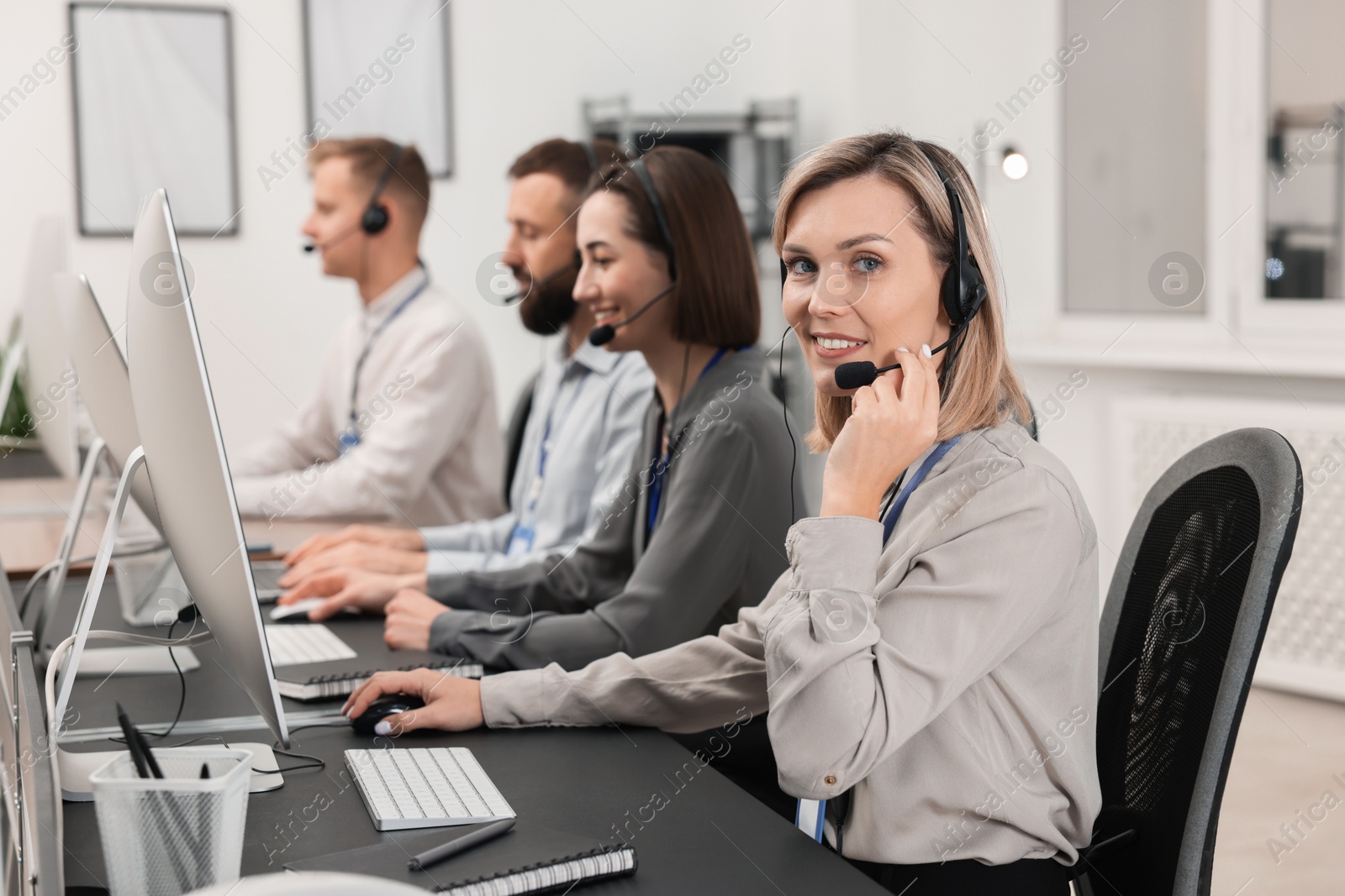 Photo of Technical support call center. Team of operators working in office