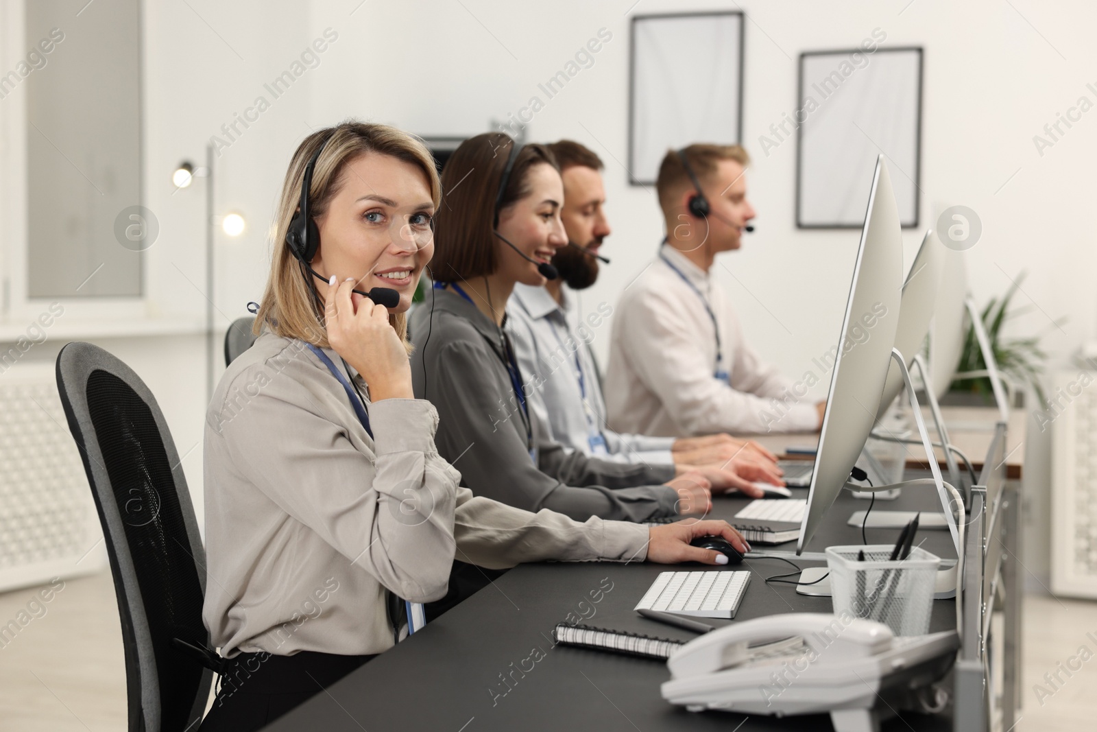 Photo of Technical support call center. Team of operators working in office